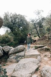 Boy walking on rocky hill