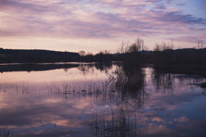 Cloudy evening sky over calm lake