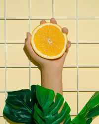 Hand holding half of orange