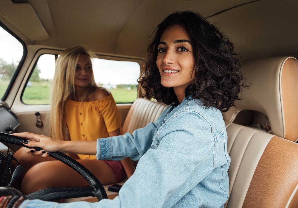 Two female friends in a car together