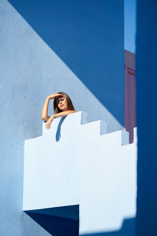 Woman standing on the top of a blue building