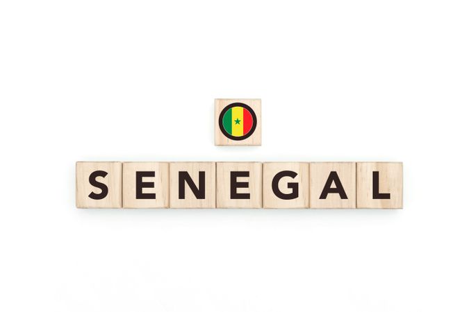 Wooden blocks bearing the name and flag of Senegal. Senegalese and North African Culture, national identity, travel, and geography in a copy space design.