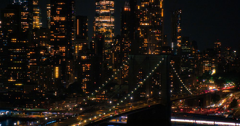 Aerial Top Down Night Scenery with Brooklyn Bridge with Car Traffic Moving in Both Directions on the Road. Helicopter Bird's-Eye View of a Popular American Travel and Business Destination