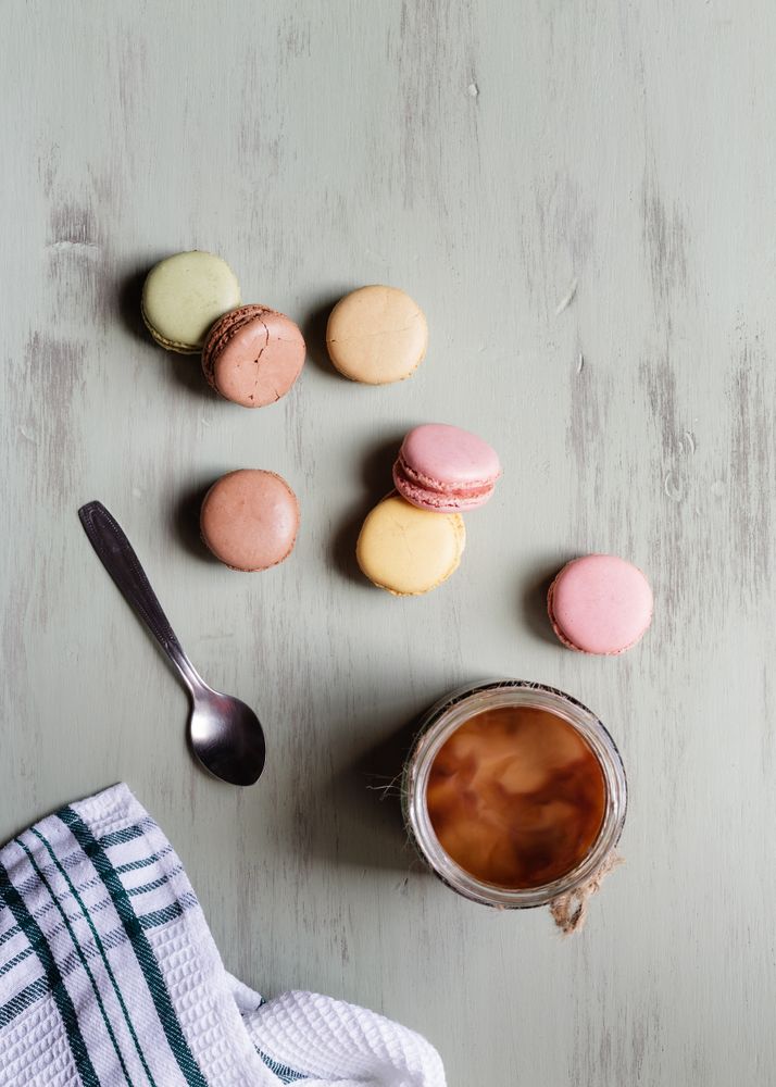 Spoon and napkin near coffee and macaroons