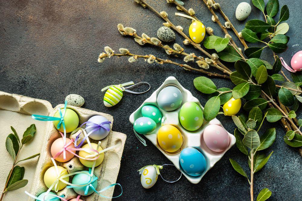 Top view of two cartons of pastel Easter eggs with ribbons