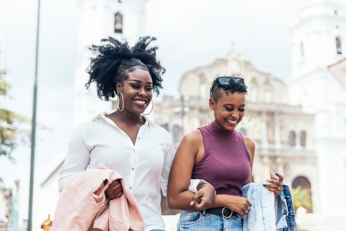 Black women talking and laughing walking in the city