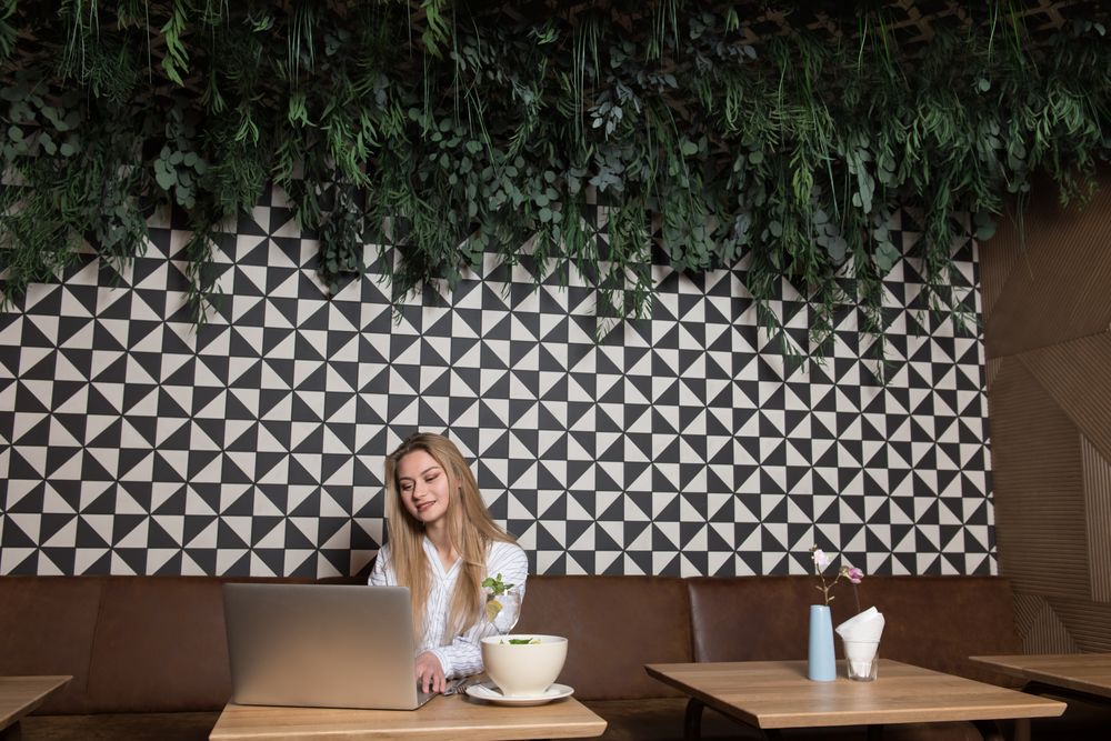 Young woman using laptop in cafe
