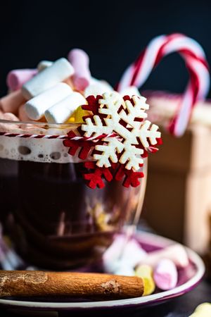 Close up of marshmallow hot chocolate on table with snowflake decoration
