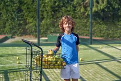 Content boy with balls on court