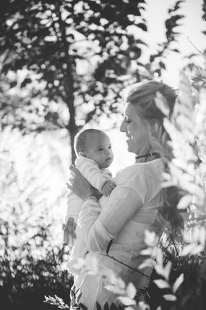baby with down syndrome in the arms of his grandmother