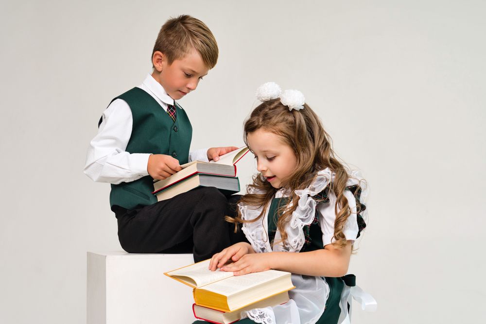 Uniform elementary school students read paper books with interest