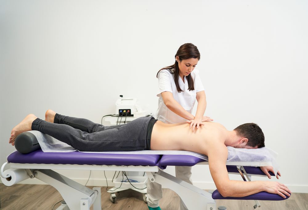 physiotherapist treating a contracture in the patient's back