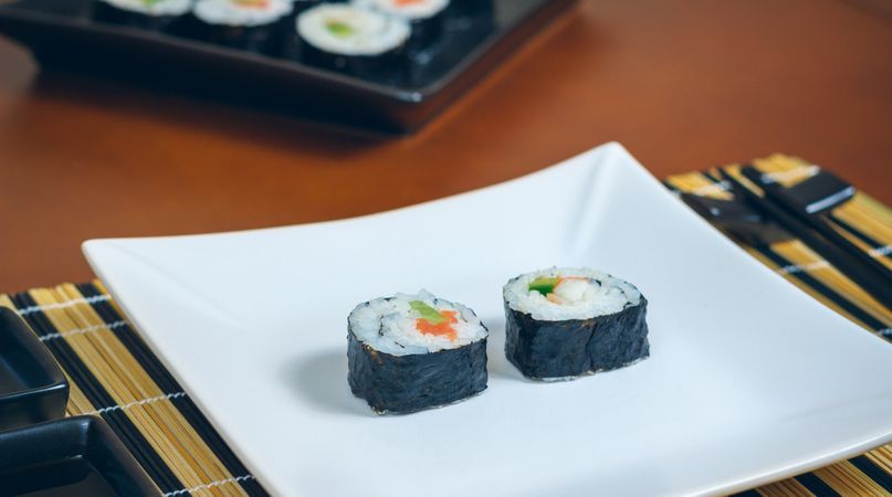 Two sushi rolls on plate ready to eat at restaurant