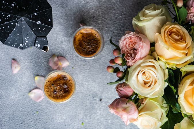 Top view of two espressos with bouquet of roses and moka