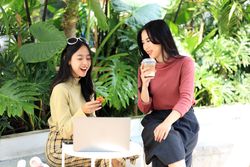 Asian Woman Chatting and Joyful with Food  and Coffee in a Coffee Shop Restaurant.