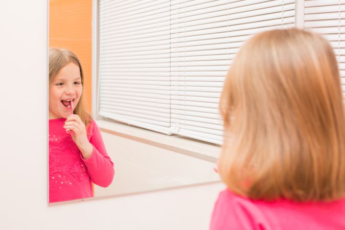 Cute girl brushing her teeth