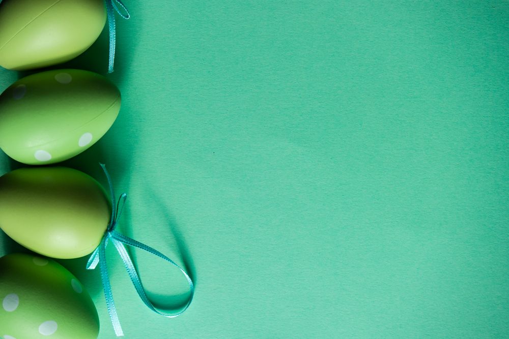 Easter holiday card concept with green ornamental eggs