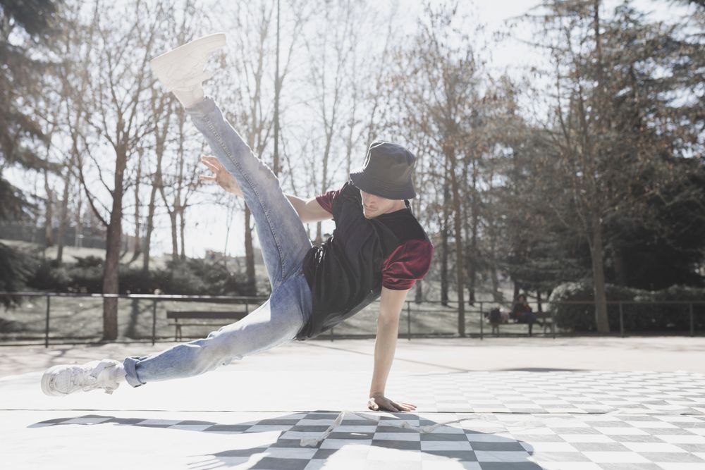 Man dancing break dance in park