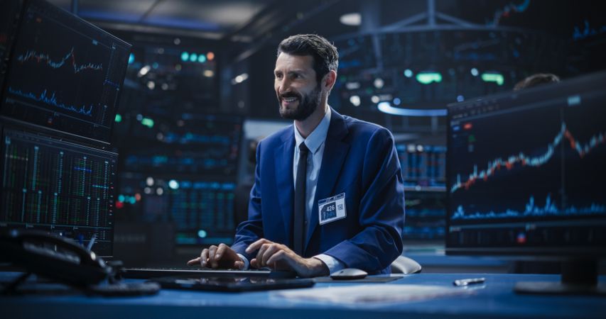 Male Specialist Typing on Keyboard, Analyzing Financial Market Reports with Graphs and Ticker Charts.