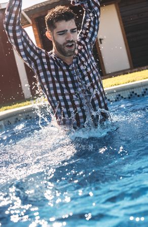 Dressed man in swimming pool