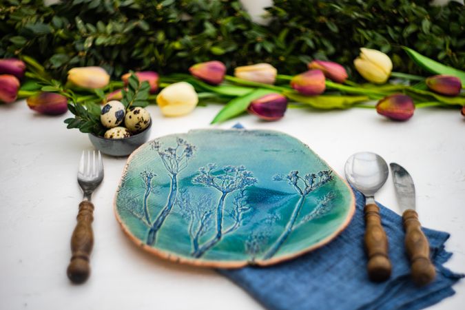 Festive table setting for Easter holiday dinner decorated with tulips