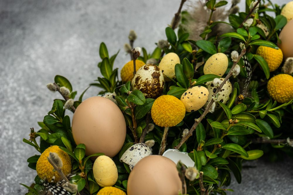 Easter card concept with wreath with eggs and branches
