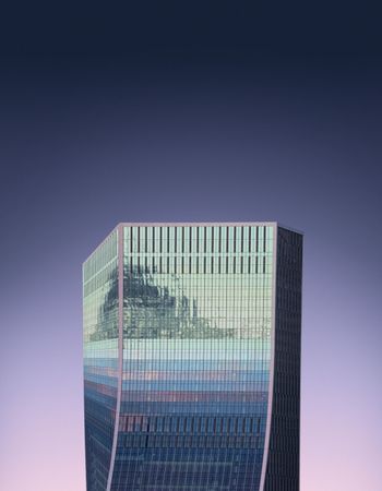 Reflective square building against a purple gradient sky