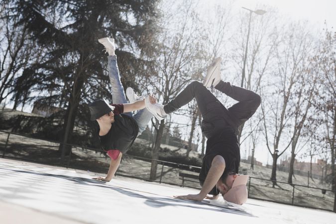 Young men dancing break dance in park