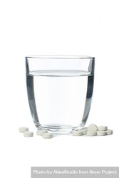 Full water glass surrounded by pills in blank background 0y3gn4