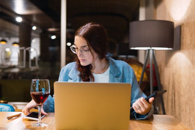 Focused female freelancer working in restaurant