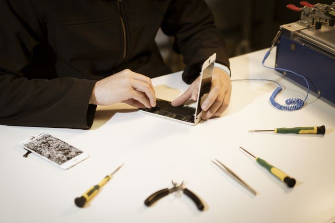 Young man repairing modern device