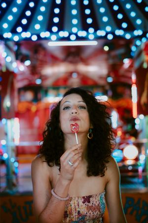 Woman with lollipop in amusement park
