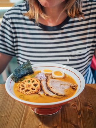 Female eating Japanese dish