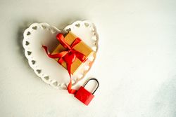 Romantic table setting with heart shaped plate and red padlock