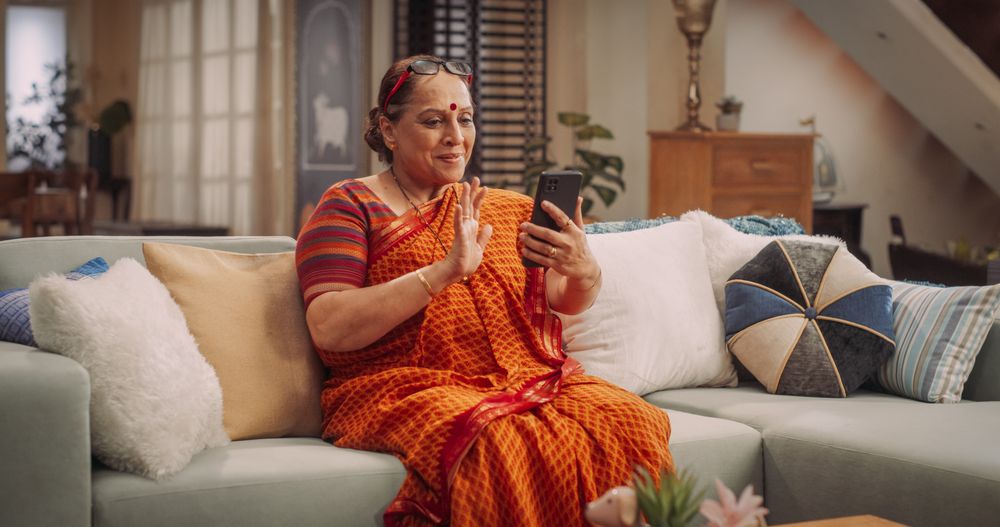 Mature Woman Using Smartphone for  Greeting Friends
