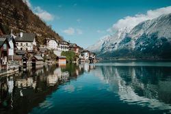 Mountain coast with houses along turquoise lake