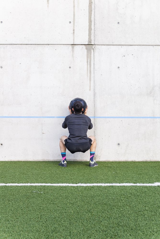 Man training with ball near wall