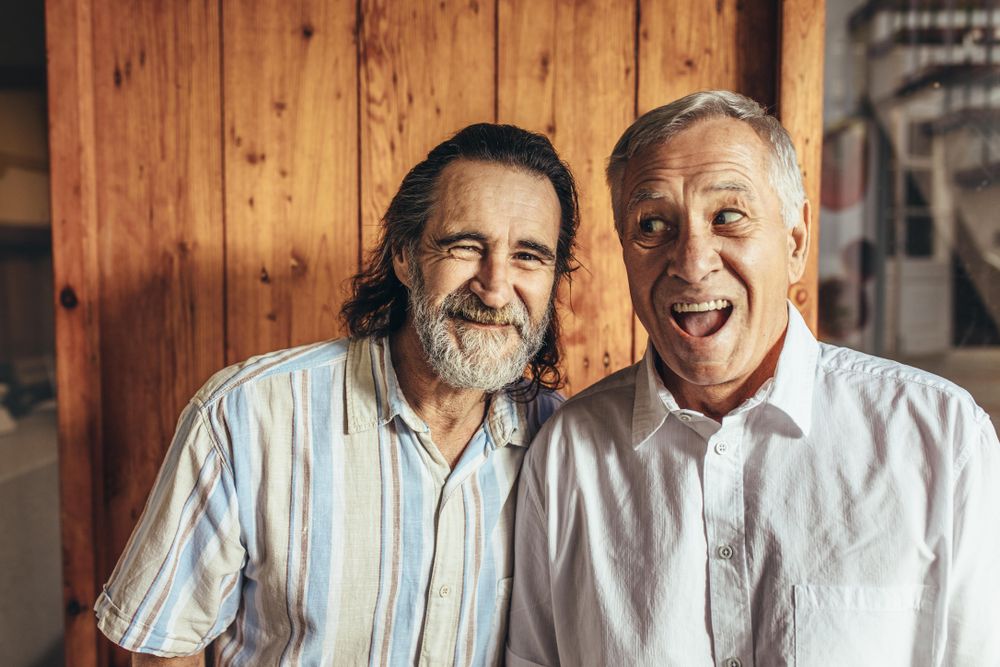 Two fun friends standing together making funny faces