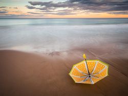 Umbrella on beach near sea