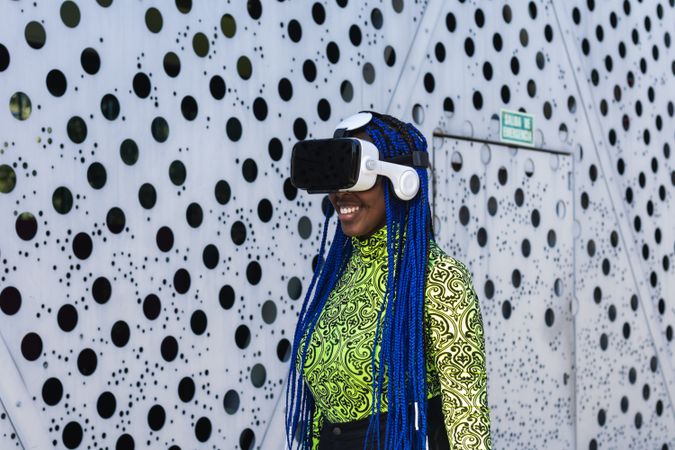 Black woman in VR headset in city