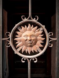 Smiling sun metal door grate
