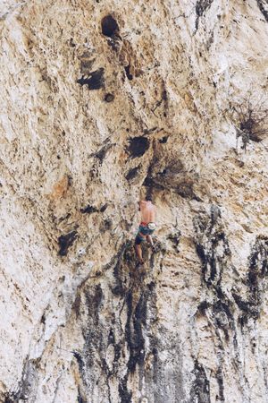 Anonymous man climbing rock