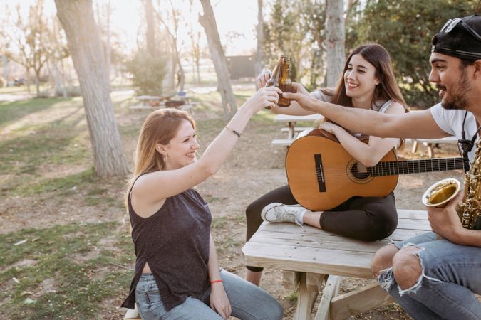 Young musicians drinking beer in park