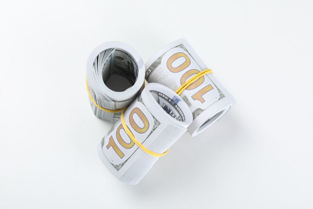 Stacks of American cash money, isolated on light background