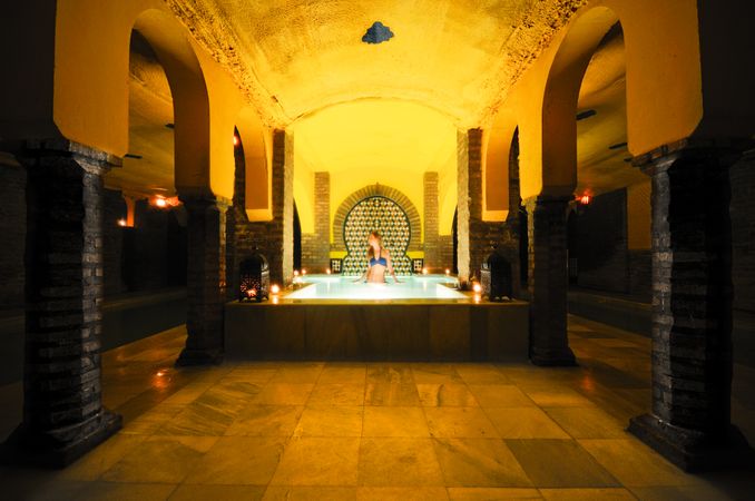 Woman taking a bath in the Arab baths in Granada, Andalucia, Spain