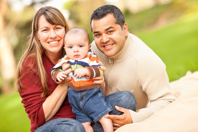 Happy  Family Posing for A Portrait in the Park