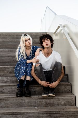 Happy couple sitting on wooden stair