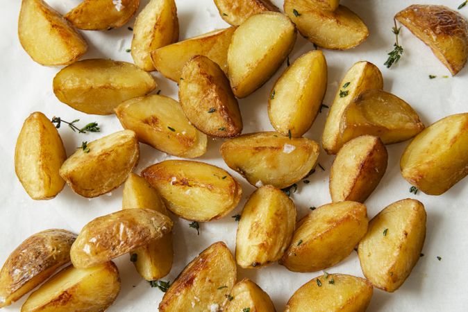 Potato wedges with thyme and salt close up