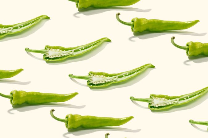 Cut green pepper among rows of whole peppers