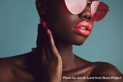 Close-up of a glamorous female model with artistic makeup wearing funky sunglasses 56lWYb
